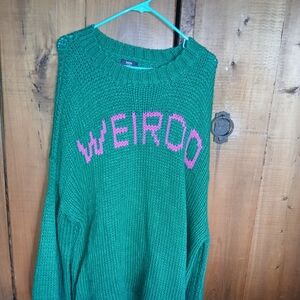 Dressed in LALA Bold Green Sweater with Pink Lettering
